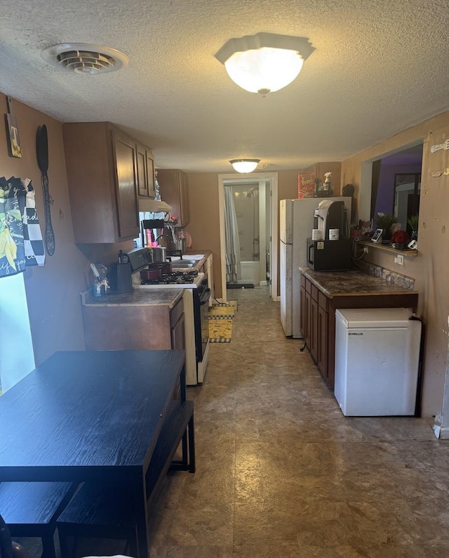 24041/2 W John St, Champaign, IL 61820 - kitchen featuring black range with gas stovetop, refrigerator, tile patterned floors, and a textured ceiling