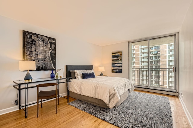 6007 N Sheridan Rd Unit 36F, Chicago, IL 60660 - bedroom with a baseboard radiator, wood finished floors, access to outside, and an office area