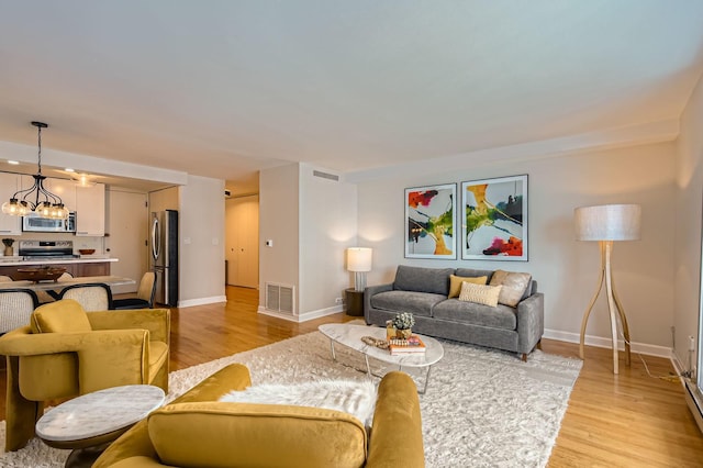 6007 N Sheridan Rd Unit 36F, Chicago, IL 60660 - living room featuring a chandelier and light wood-style flooring