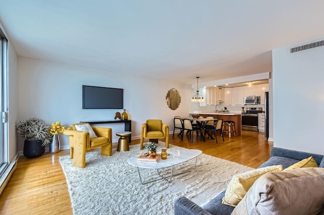 6007 N Sheridan Rd Unit 36F, Chicago, IL 60660 - living room featuring light wood-style floors and baseboard heating