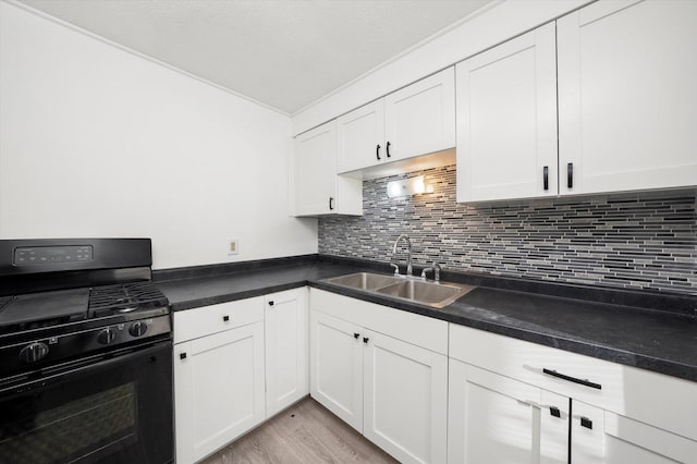 12216 S Carpenter St, Chicago, IL 60643 - kitchen featuring black gas range oven, white cabinets, light wood-type flooring, backsplash, and dark countertops