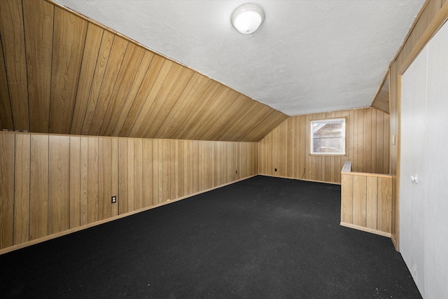 12216 S Carpenter St, Chicago, IL 60643 - bonus room featuring wooden walls, lofted ceiling, and a textured ceiling