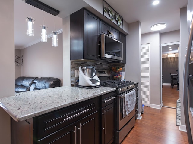1 Oak Creek Dr Unit 2305, Buffalo Grove, IL 60089 - kitchen featuring stainless steel appliances, wood finished floors, backsplash, light stone counters, and ornamental molding