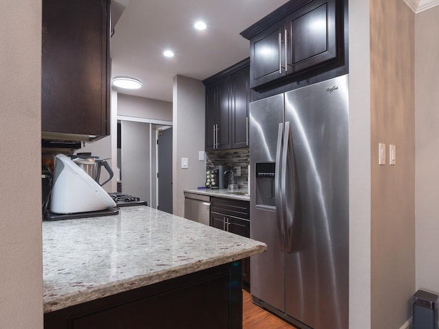 1 Oak Creek Dr Unit 2305, Buffalo Grove, IL 60089 - kitchen featuring stainless steel appliances, tasteful backsplash, light wood finished floors, recessed lighting, and light stone countertops