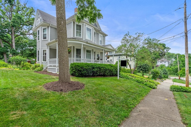 311 Nicholson St, Joliet, IL 60435 - view of front of house featuring covered porch, a front lawn, and a chimney