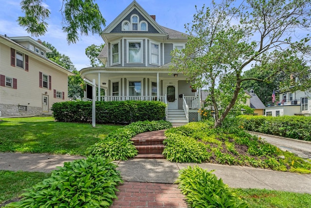311 Nicholson St, Joliet, IL 60435 - victorian house featuring covered porch and a front lawn