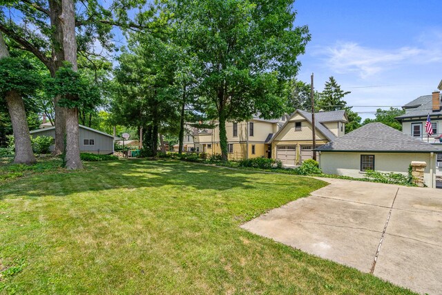 311 Nicholson St, Joliet, IL 60435 - view of grassy yard featuring a garage