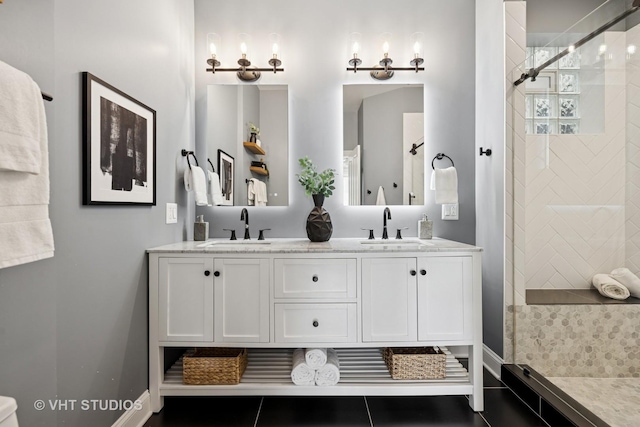 2259 W Wabansia Ave Unit 309, Chicago, IL 60647 - bathroom featuring double vanity, tiled shower, and tile patterned floors