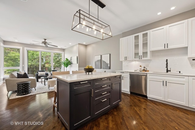 2259 W Wabansia Ave Unit 309, Chicago, IL 60647 - kitchen with dishwasher, white cabinetry, dark wood-style floors, backsplash, and glass insert cabinets