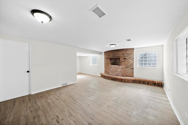 3508 Maple Ln, Hazel Crest, IL 60429 - unfurnished living room with wood finished floors, plenty of natural light, and a fireplace
