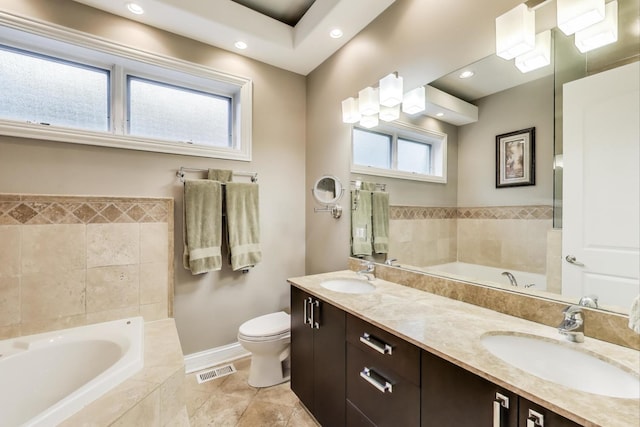 2011 W Huron St, Chicago, IL 60612 - bathroom featuring a bath, double vanity, recessed lighting, and tile patterned floors