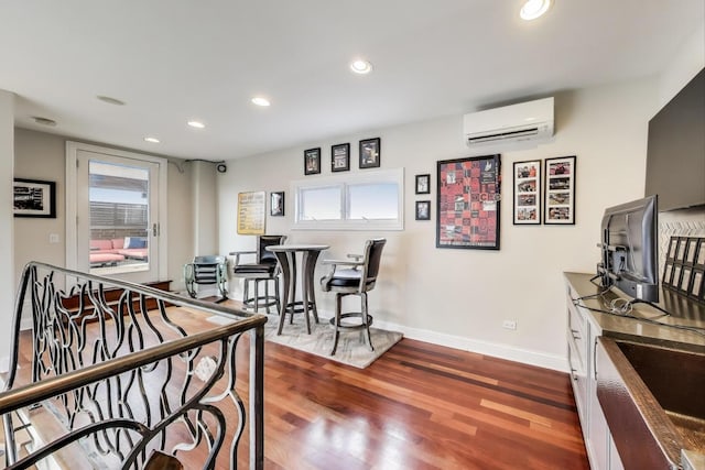 2011 W Huron St, Chicago, IL 60612 - game room featuring a wall unit AC, recessed lighting, and dark wood-type flooring
