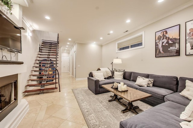 2011 W Huron St, Chicago, IL 60612 - living room with a fireplace with raised hearth, light tile patterned floors, recessed lighting, stairs, and crown molding