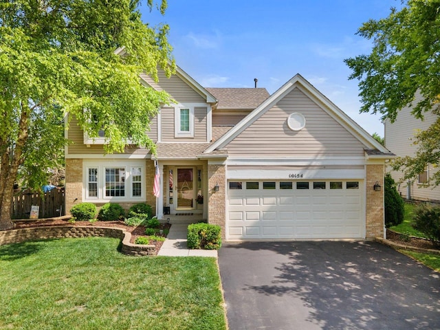10154 Ashley St, Huntley, IL 60142 - traditional-style house featuring brick siding, asphalt driveway, a garage, and roof with shingles