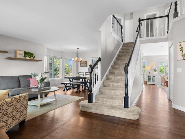 10154 Ashley St, Huntley, IL 60142 - stairway featuring a chandelier and wood finished floors