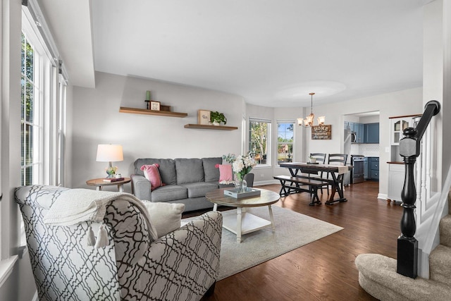10154 Ashley St, Huntley, IL 60142 - living room featuring dark wood-style floors, a chandelier, and stairway
