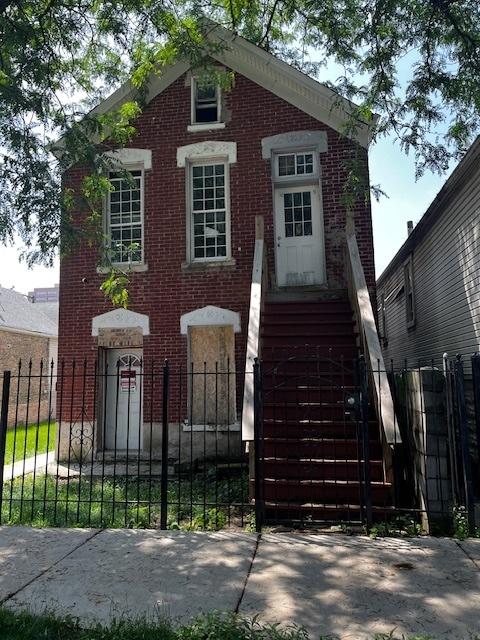 2911 W 25th St, Chicago, IL 60623 - view of front of home featuring brick siding and a fenced front yard