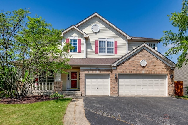 2208 Sanctuary Ct, Gurnee, IL 60031 - view of front of property with driveway, brick siding, and covered porch
