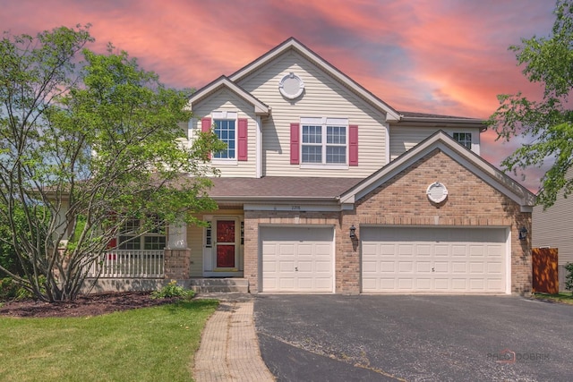 2208 Sanctuary Ct, Gurnee, IL 60031 - view of front of home with driveway, brick siding, and covered porch