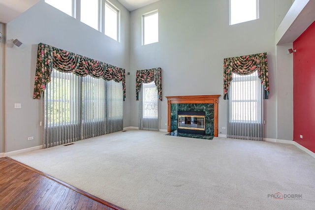 2208 Sanctuary Ct, Gurnee, IL 60031 - unfurnished living room featuring a high ceiling, carpet flooring, and plenty of natural light