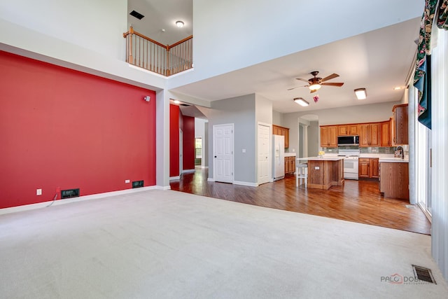 2208 Sanctuary Ct, Gurnee, IL 60031 - unfurnished living room featuring dark carpet, a ceiling fan, and dark wood finished floors