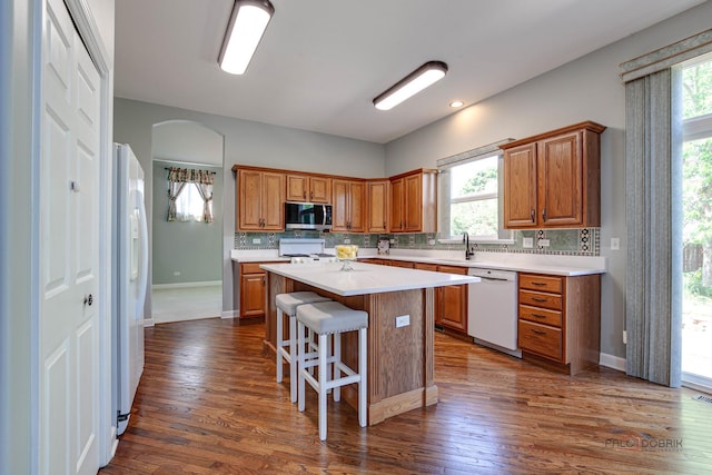 2208 Sanctuary Ct, Gurnee, IL 60031 - kitchen with white appliances, light countertops, a center island, and brown cabinetry
