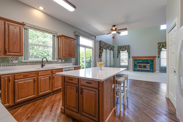 2208 Sanctuary Ct, Gurnee, IL 60031 - kitchen with a kitchen bar, brown cabinets, a premium fireplace, light countertops, and recessed lighting
