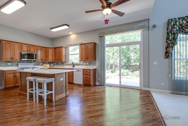 2208 Sanctuary Ct, Gurnee, IL 60031 - kitchen with stainless steel microwave, white dishwasher, light countertops, and backsplash