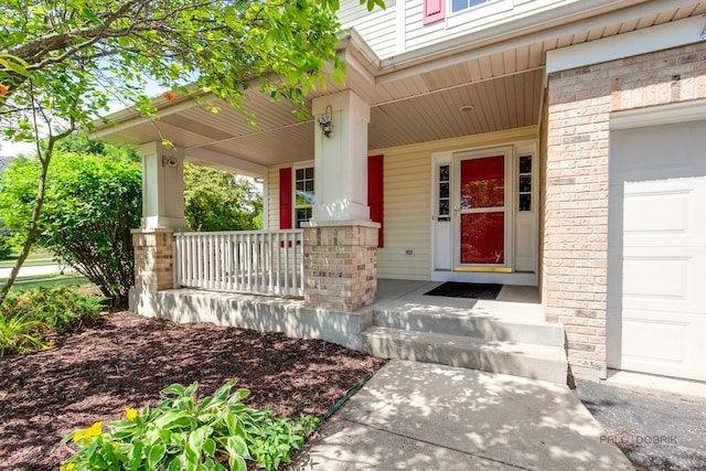 2208 Sanctuary Ct, Gurnee, IL 60031 - property entrance featuring covered porch and a garage