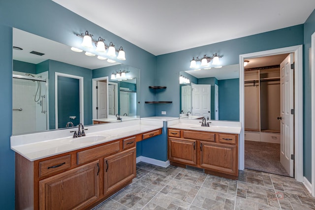 2208 Sanctuary Ct, Gurnee, IL 60031 - full bathroom featuring a stall shower, two vanities, stone finish floors, and a closet