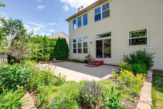 2208 Sanctuary Ct, Gurnee, IL 60031 - rear view of property featuring a patio, a chimney, and entry steps