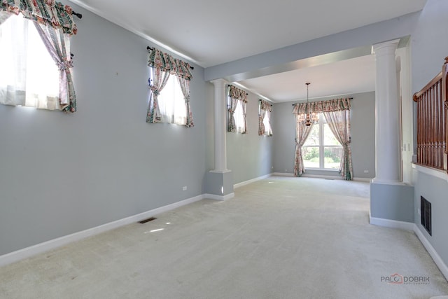 2208 Sanctuary Ct, Gurnee, IL 60031 - spare room featuring decorative columns, carpet floors, and a chandelier