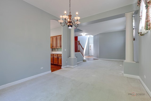 2208 Sanctuary Ct, Gurnee, IL 60031 - unfurnished dining area featuring light colored carpet, stairway, a chandelier, and decorative columns
