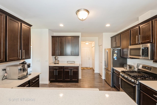 16212 W Switch Grass Rd, Lockport, IL 60441 - kitchen with appliances with stainless steel finishes, dark brown cabinetry, dark wood-type flooring, recessed lighting, and light stone countertops