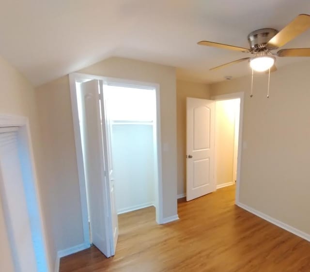 4936 W Harrison St, Chicago, IL 60644 - unfurnished bedroom featuring light wood finished floors, vaulted ceiling, and ceiling fan