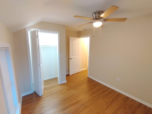 4936 W Harrison St, Chicago, IL 60644 - unfurnished bedroom featuring light wood finished floors, vaulted ceiling, and a ceiling fan