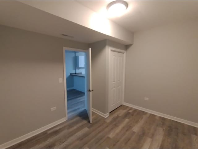 4936 W Harrison St, Chicago, IL 60644 - unfurnished bedroom with wood finished floors and baseboards