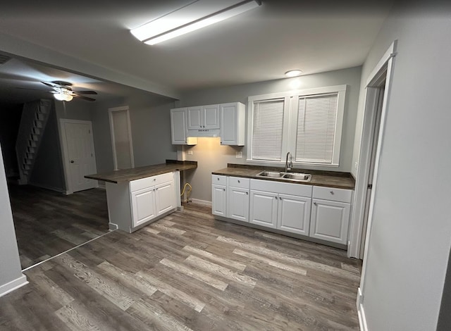 4936 W Harrison St, Chicago, IL 60644 - kitchen featuring butcher block counters, wood finished floors, white cabinets, and ceiling fan
