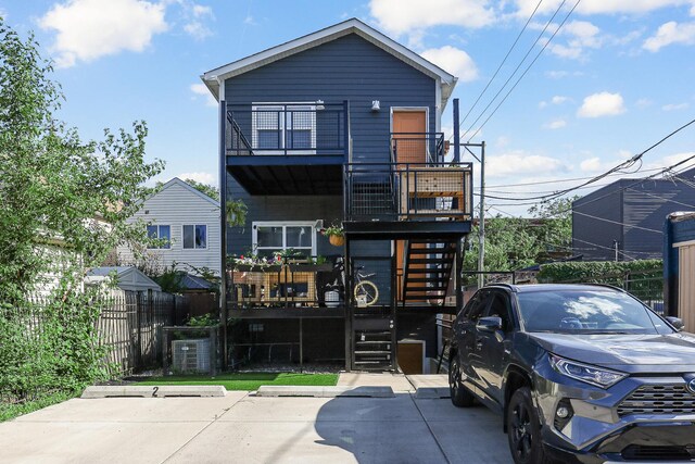 1538 W 21st St Unit 1, Chicago, IL 60608 - view of front facade featuring stairway and a balcony