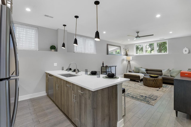 1538 W 21st St Unit 1, Chicago, IL 60608 - kitchen featuring appliances with stainless steel finishes, a peninsula, light wood-style floors, ceiling fan, and recessed lighting