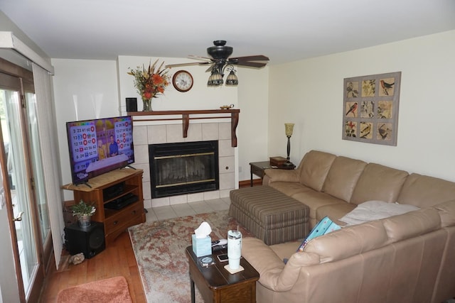 4914 W State Route 113, Kankakee, IL 60901 - living room featuring light wood-type flooring, a tiled fireplace, and ceiling fan