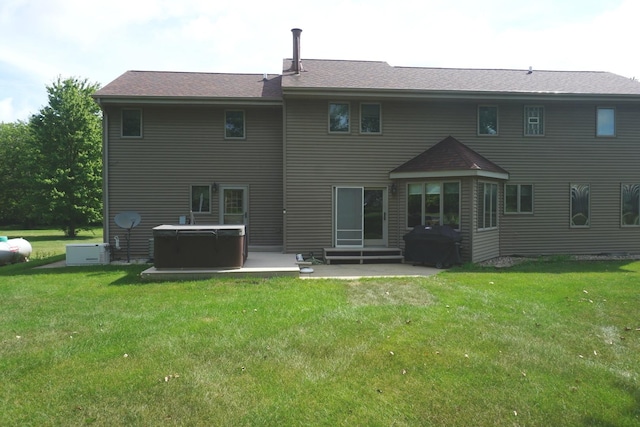 4914 W State Route 113, Kankakee, IL 60901 - rear view of house featuring a hot tub, a lawn, a patio, and entry steps