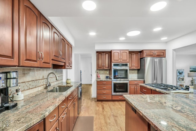 2310 Malik Ct, Glenview, IL 60025 - kitchen with stainless steel appliances, light stone countertops, light wood-style floors, tasteful backsplash, and brown cabinetry