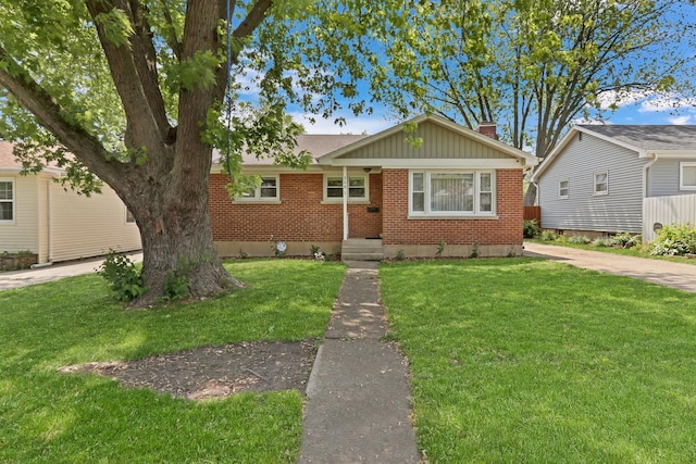 308 Dalton Ave, Mundelein, IL 60060 - view of front of home featuring brick siding, a front lawn, and a chimney
