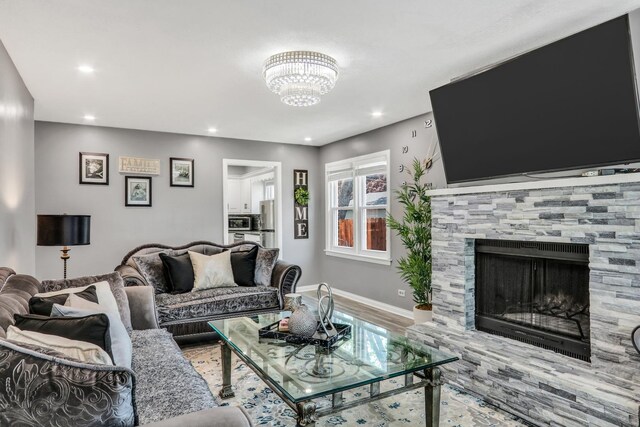 308 Dalton Ave, Mundelein, IL 60060 - living room with recessed lighting, wood finished floors, a fireplace, and a chandelier