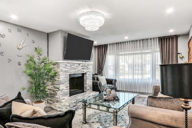 308 Dalton Ave, Mundelein, IL 60060 - living area featuring wood finished floors, a stone fireplace, a chandelier, and recessed lighting
