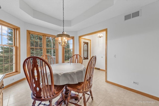 31-58 Wakonda Dr, Lake Carroll, IL 61046 - dining room featuring a chandelier, a raised ceiling, and light tile patterned floors