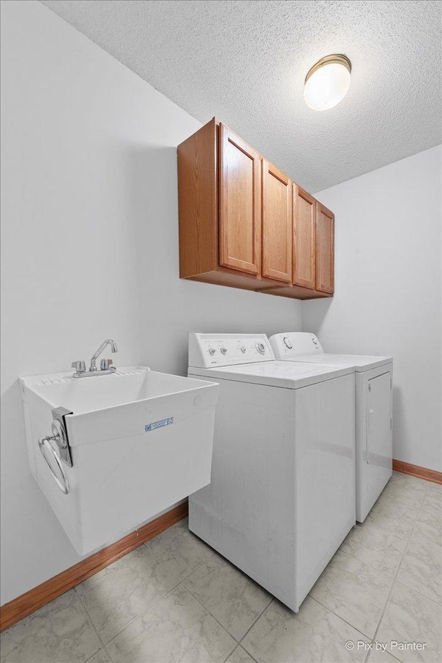 31-58 Wakonda Dr, Lake Carroll, IL 61046 - laundry room with independent washer and dryer, cabinet space, light marble finish floors, and a textured ceiling