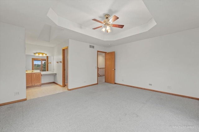 31-58 Wakonda Dr, Lake Carroll, IL 61046 - unfurnished bedroom featuring a raised ceiling, light carpet, ensuite bathroom, and a ceiling fan