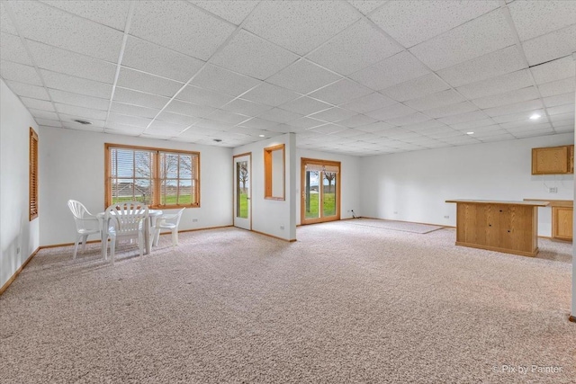 31-58 Wakonda Dr, Lake Carroll, IL 61046 - unfurnished living room featuring a paneled ceiling, light colored carpet, and healthy amount of natural light